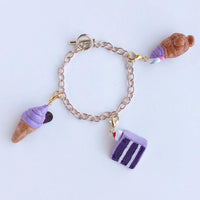 For those of you in a total ube mood, this charm bracelet includes all three of the charms from the Ube Collection: the Ube Soft Serve, the Ube Cake Slice, and the  Ube Taiyaki Ice Cream. Make a bright, bold, and sweet statement with any outfit! The Ube Charm Bracelet is the perfect gift to those with a big sweet tooth and are in love with novelty jewelry.