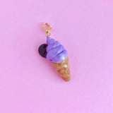 This decadent ube ice cream charm is handmade with polymer clay, hand painted with acrylic paint, and coated in resin. Made to last! This charm can be used on a charm bracelet, necklace chain, or as a keychain on the zipper of your favorite bag! Give your outfits a cute pop of sugar to show your sweet side.